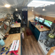 Image for article titled This Wild School Bus RV Has Underglow And A Fire Pit On Its Roof